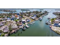 Waterfront home with multiple docks and boat lifts provides direct access to the Gulf of Mexico at 253 Boca Ciega Dr, Madeira Beach, FL 33708