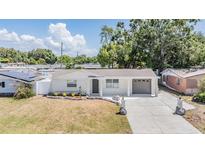 Charming single-story home with well-maintained front yard, attached garage, and inviting curb appeal at 3445 Pinehurst Dr, Holiday, FL 34691