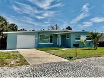 Charming single-story home with a well-maintained lawn, attached garage, and a clean, modern facade at 440 89Th Ave, St Pete Beach, FL 33706