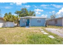 Charming single-story home with a blue exterior, small porch and front yard at 513 88Th N Ave, St Petersburg, FL 33702