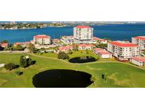A captivating aerial view of the condo community, showcasing lush lawns, serene ponds, and stunning waterfront vistas at 6265 Sun Blvd # 605, St Petersburg, FL 33715