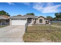 Charming single Gathering home with a two-car garage and a well-maintained front yard in a desirable neighborhood at 7222 N Amos Ave, Tampa, FL 33614