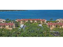 Panoramic aerial view of waterfront condos with red tile roofs, lush landscaping, and stunning water views at 7520 Sunshine Skyway S Ln # 109, St Petersburg, FL 33711