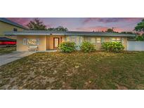 Charming single-story home featuring a well-maintained lawn and inviting entrance with updated windows at 1412 Coburn Dr, Tarpon Springs, FL 34689