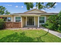Inviting home entrance with well-maintained lawn and neutral exterior, providing a warm welcome at 15202 Morning Dr, Lutz, FL 33559
