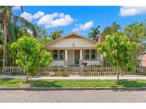 Charming single-story home featuring a manicured front yard and a quaint picket fence at 1530 21St N Ave, St Petersburg, FL 33704