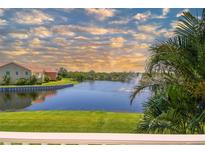 Scenic water view featuring a fountain, lush greenery, and glimpses of nearby homes under a partly cloudy sky at 17 Franklin S Ct # C, St Petersburg, FL 33711