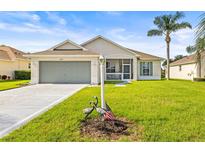 Charming single-story home with a well-maintained lawn, lovely landscaping, and a two-car garage at 2227 North Creek Ct, Sun City Center, FL 33573