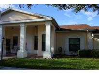 Charming single-story home featuring a well-maintained lawn and a welcoming, column-supported entryway at 311 Kelsey Way # 3, Sun City Center, FL 33573