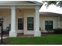 Inviting front porch with brick flooring and decorative pillars at 311 Kelsey Way # 3, Sun City Center, FL 33573