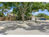 Charming single-story home featuring a gravel yard, mature trees, and detached garage at 4021 Vana Dr, Sarasota, FL 34241
