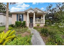 Charming single-story home with a covered porch and lush landscaping at 502 Lincoln Ave, Tarpon Springs, FL 34689