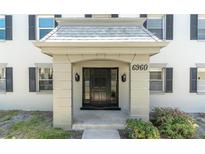 Inviting front entrance of home with black door, stylish lighting, and elegant architectural details at 6960 Sunset S Dr # 2B, South Pasadena, FL 33707