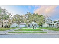 Charming one-story home features a circular driveway and unique stone accents at 7033 Wentworth Way, New Port Richey, FL 34655