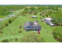 Expansive property with a pool, outbuildings, and a well-maintained lawn at 13341 Hexam Rd, Weeki Wachee, FL 34613