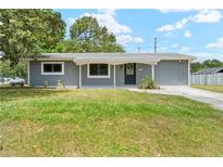 Charming single-story home featuring a well-kept lawn and inviting entrance at 1569 Larkin Rd, Spring Hill, FL 34608