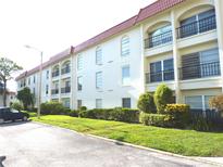 Charming condominium complex featuring private balconies, lush landscaping, and a well-maintained facade at 2700 Bayshore Blvd # 2110, Dunedin, FL 34698