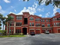 Beautiful multi-story condo building featuring garage parking and a tile roof at 2713 Via Murano # 210, Clearwater, FL 33764