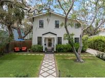 Charming two-story home with inviting walkway, lush landscaping, and well-manicured front yard at 3011 Harbor View, Tampa, FL 33611