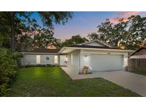 Charming one-story home featuring an attached two-car garage and a well-manicured front lawn at 3205 Coventry N, Safety Harbor, FL 34695