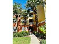 Charming condo exterior with palm trees and a well-maintained walkway and colorful paint at 4207 S Dale Mabry Hwy # 9106, Tampa, FL 33611