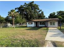 Charming single-story home featuring a well-manicured lawn and covered front entrance, perfect for curb appeal at 502 Johnson Rd, Plant City, FL 33566