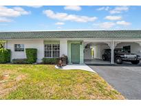 Charming home featuring a well-maintained lawn, covered parking, and a quaint entrance at 7850 40Th N Ave # 7850, St Petersburg, FL 33709