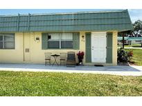 Charming condo with green shutters, front door, and room for seating to enjoy the outdoors at 102 Cambridge Trl # 230, Sun City Center, FL 33573