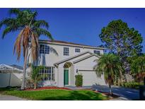 Charming two-story home featuring lush landscaping and a well-manicured front lawn at 1204 Rinkfield Pl, Brandon, FL 33511