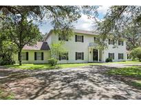 Spacious two-story home with traditional architectural details, black shutters, and balcony at 12433 Kelso Rd, Thonotosassa, FL 33592