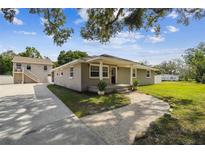 Charming single story home featuring a covered front porch and well-manicured lawn at 205 W 122Nd Ave, Tampa, FL 33612