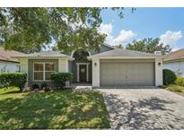 Charming single-story home featuring a well-manicured lawn and a two-car garage at 2617 Heatherwood Dr, Tampa, FL 33618