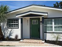 Inviting front door with a green painted finish and a charming, covered entryway at 4511 Hampshire Rd, Tampa, FL 33634