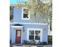 Charming townhouse featuring a red door and light blue exterior paint at 5303 Terraza Ct, Temple Terrace, FL 33617