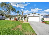 Charming single-story home with a two-car garage, lush lawn, and mature trees offering shade at 5925 18Th Ne St, St Petersburg, FL 33703