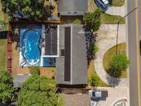 Aerial view of a home featuring a large swimming pool, solar panels, and well-maintained landscaping at 5968 46Th N Ave, Kenneth City, FL 33709