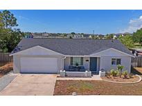 Charming single Gathering home with a brick facade, gray roof, and landscaping at 6137 Halifax Dr, New Port Richey, FL 34653