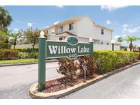 Inviting Willow Lake condo complex sign with manicured landscaping and clear community address at 6400 46Th N Ave # 203, Kenneth City, FL 33709