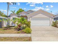 Charming single-story home with a two-car garage and a well-manicured lawn, showcasing curb appeal at 6741 51St N Way, Pinellas Park, FL 33781