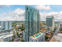 Stunning high-rise building with a pool deck and panoramic views of the cityscape under a bright blue sky at 777 N Ashley Dr # 1506, Tampa, FL 33602