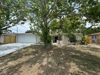 Charming single-story home with large front yard and beautiful mature shade trees at 7831 Fox Hollow Dr, Port Richey, FL 34668