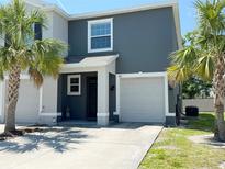 Two-story home with a two-car garage, palm trees, and a well-maintained front lawn at 821 Lucent Sands Ct, Brandon, FL 33511