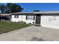 Charming single-story home featuring a well-maintained lawn and a concrete driveway at 8665 55Th N St, Pinellas Park, FL 33782