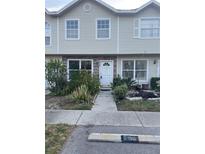 Charming townhouse featuring neutral siding, brick accents, and a well-maintained front garden at 8708 Cobbler Pl, Tampa, FL 33615