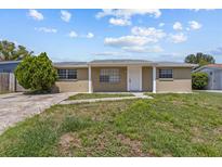 Charming single-story home featuring a tidy front yard and neutral-toned exterior at 9915 Aetna Ln, Port Richey, FL 34668