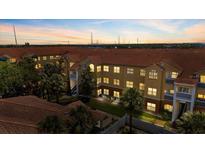 Beautiful condo building with a red tile roof and lush landscaping at 10764 70Th Ave # 3206, Seminole, FL 33772