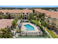 Community pool surrounded by lush landscaping and lounge chairs for relaxing and enjoying the Florida sunshine at 10764 70Th Ave # 3206, Seminole, FL 33772