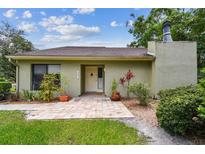 Charming single-story home with a brick-paved entrance and well-maintained landscaping at 13501 Palmwood Ln # 0, Tampa, FL 33618