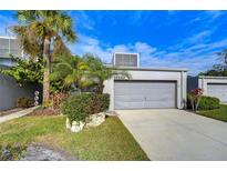 Charming condo with a well maintained lawn, tropical landscaping, and attached one car garage at 13635 Twin Lakes Ln # 13635, Tampa, FL 33618