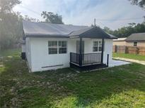 Charming single-story home featuring a covered porch and newly painted exterior at 18127 Us Highway 41, Spring Hill, FL 34610